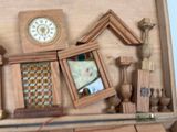 a wooden case with a clock and other items on top of it