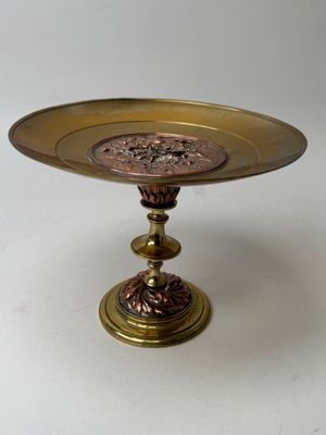a gold plate with a flower design on it