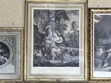 three framed pictures on the wall of a living room