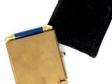 a small gold box with a black cloth on it