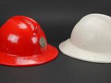 pair of red and white hard hats sitting on top of each other
