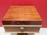 a small wooden box with a drawer on top of it