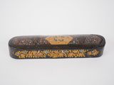 a black and gold box with a floral design on it