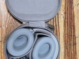 a pair of headphones in a case on a wooden floor