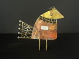 an image of a metal bird with a tag on it ' s neck