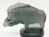 a glass figurine of a boar on a black base