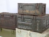 many old military boxes stacked on top of each other