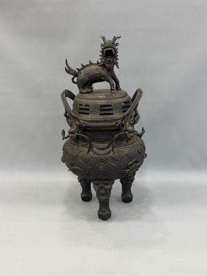 an image of a bronze statue of a dragon on top of a pot