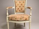 an image of a chair with a floral upholstered back and arms