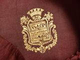 a close up of a jacket with a gold emblem on it