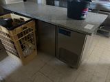 an image of a kitchen with a counter top and a trash can