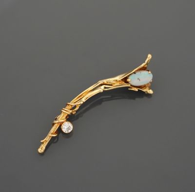 Broche en or jaune 18K 750 millièmes figurant un branche orn…