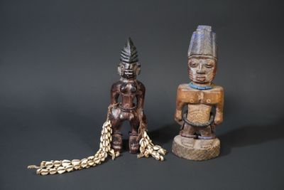 two figurines sitting next to each other on a table