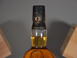 a bottle of whisky sitting on a table next to a box