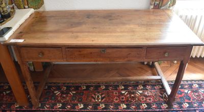 a wooden table with two drawers on top of it