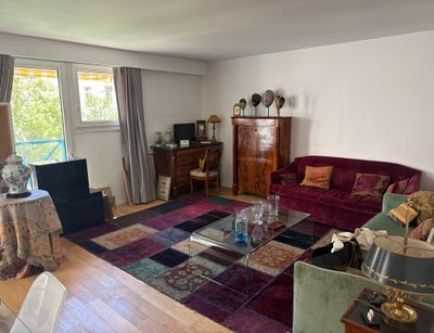 a living room with a couch, chair, coffee table and a television