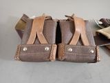 a pair of leather holsters sitting on a table