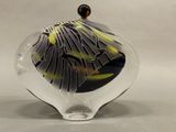 a glass vase with a black and yellow design on it