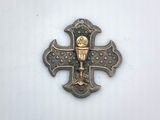 an image of a metal cross with a candle on it
