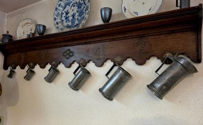 a shelf that has a bunch of cups and plates on it