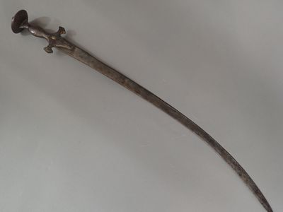 a very old sword that is laying on a table