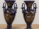 two vases that are sitting on a table