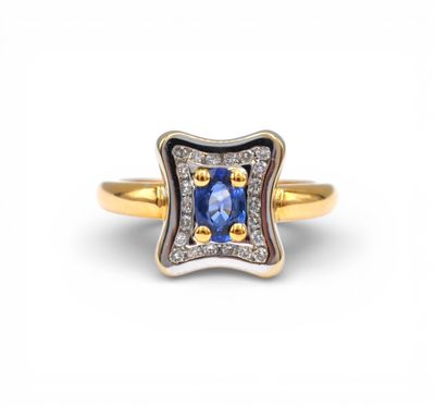 a yellow gold ring with a blue sapphire and diamonds