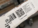 a person holding a box with a barcode on it