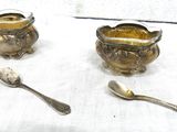 several spoons and spoon rest on a table with a white table cloth