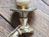 a brass candle holder with a bird on it