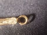 an image of a piece of gold on a black surface