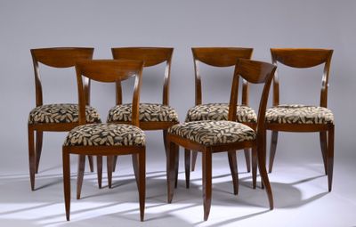 quatre chaises en bois dont les assises sont recouvertes d'un tissu à motif zébré, dans une pièce