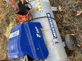 a blue and silver air compressor sitting on the ground