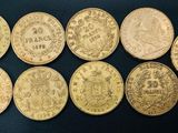 a group of six gold coins sitting on top of a black surface