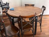a table and chairs in a room with wood flooring