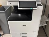 a printer that is sitting on the floor next to a trash can