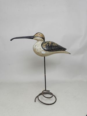 an image of a bird on a metal stand