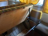 a bed with a yellow curtain on top of it