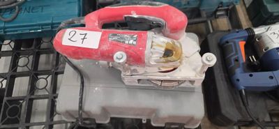 a red blower sitting on top of a table next to other tools
