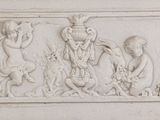 a white relief of a group of people on a wall