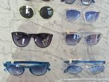 several pairs of sunglasses on a table with price tags on them