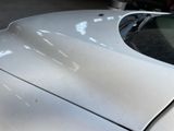 a close up of the hood of a car in a garage