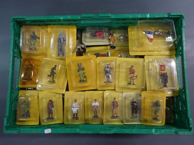 a green box filled with plastic figurines of soldiers