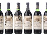 six bottles of red wine are lined up in a row