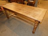 a wooden table with a wooden top in a room