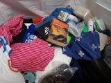 a pile of clothes and other items in a trash can