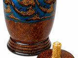 a blue and brown vase with a lid on a white background