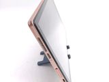 a tablet computer sitting on a stand on a white surface