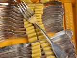 many forks and spoons in a yellow case