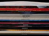 a lot of books that are stacked on top of each other